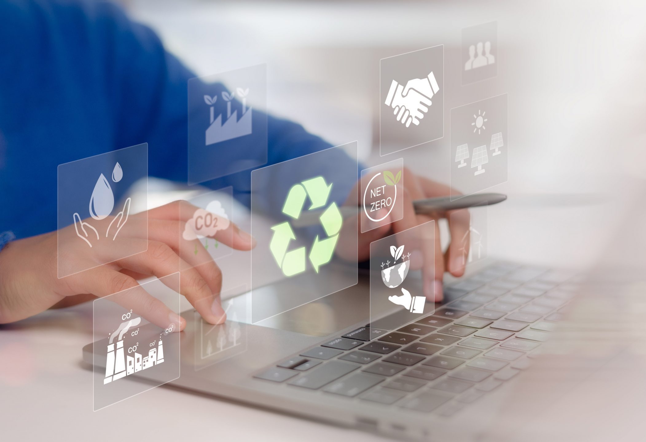 Women using a laptop with virtual icons related to recycling, renewable energy, and environmental protection. Sustainable development planning concept. ESG business sustainability investment strategy